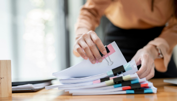 Businesswoman hands working in Stacks of paper files for searching